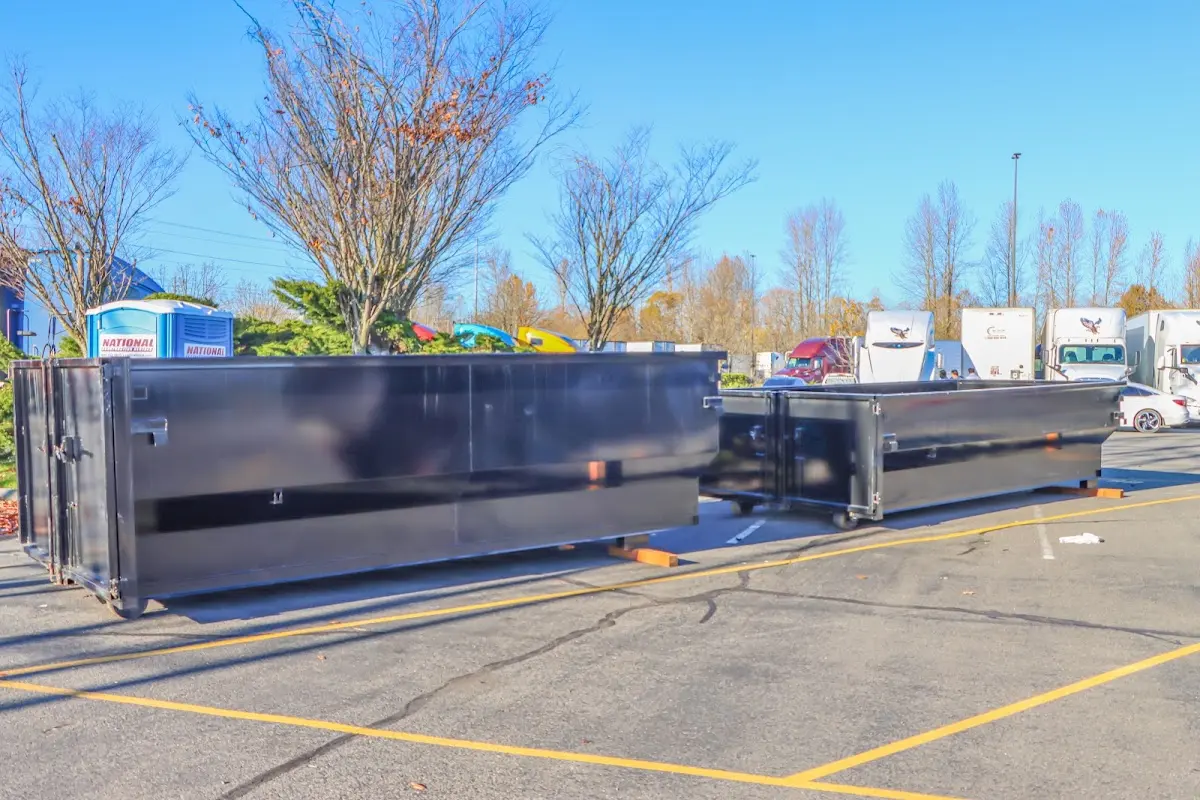 Professional dumpster rental service with roll-off container on residential driveway in Litchfield Park